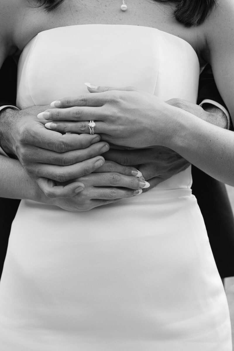 Black and white: their hands together, rings on