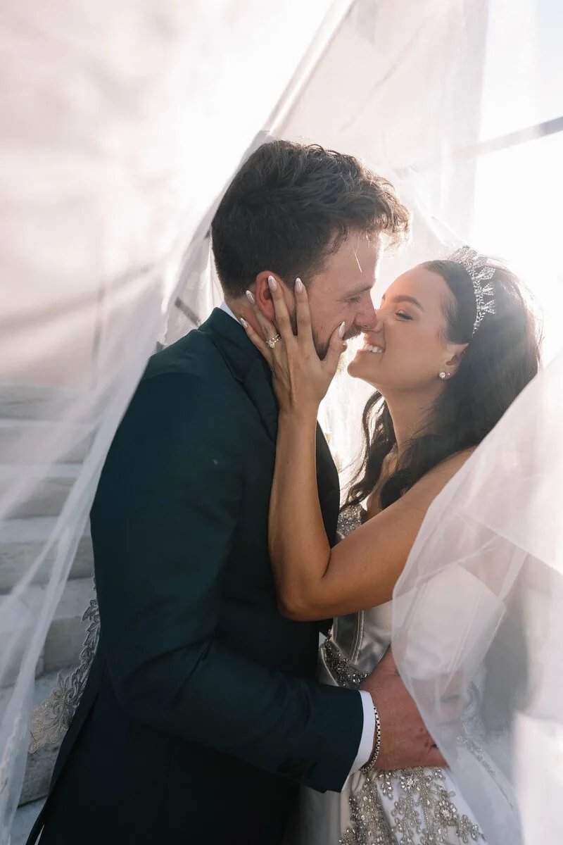 Bride and groom kissing beneath her veil, by Aurora Adeleigh, Augusta GA wedding photographer