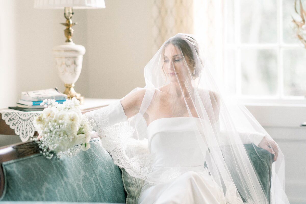 Bride in her veil, seated in a sunlit room, by Aurora Adeleigh, Augusta GA wedding photographer