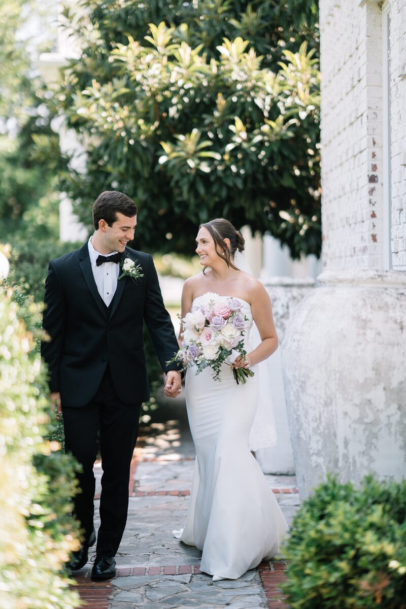 The couple walking along a garden path