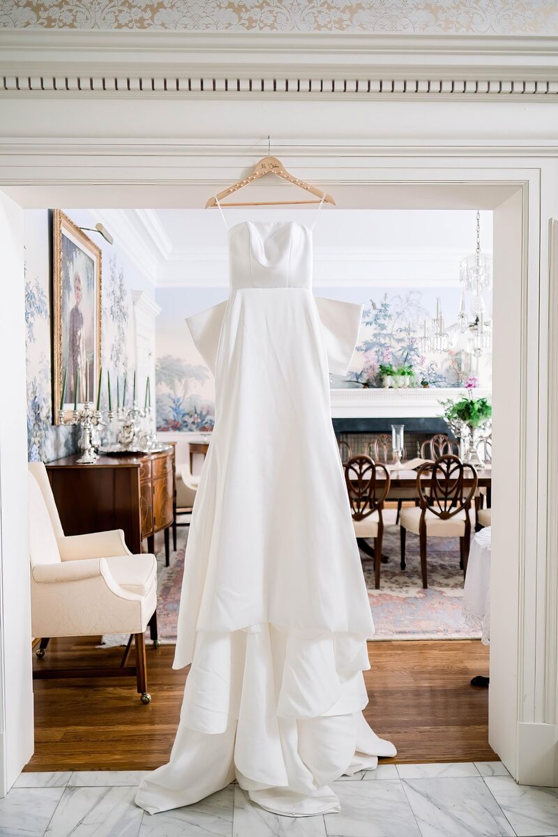 The wedding dress hanging in a doorway