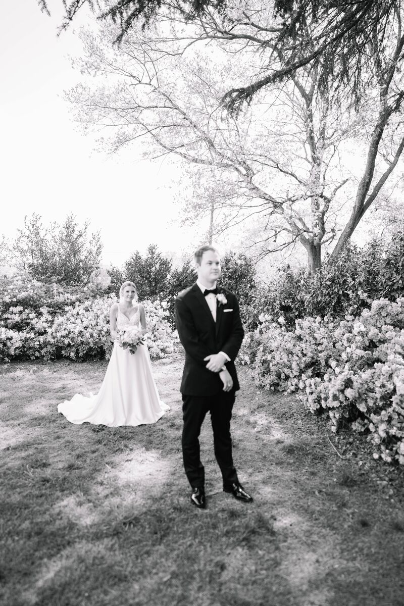 Black and white first look in a garden, from an Aurora Adeleigh wedding film