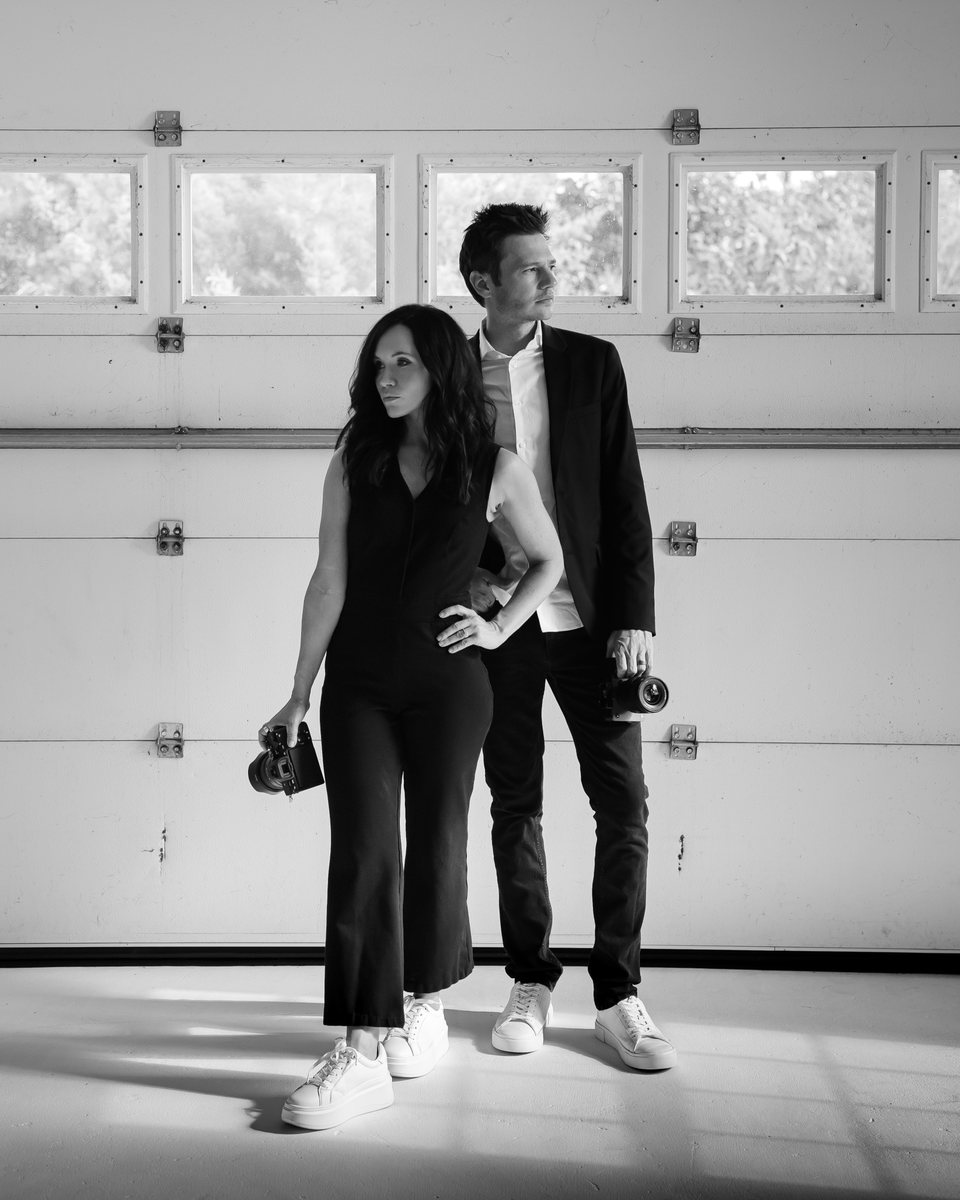 Justin and Calie Cook, founders of Aurora Adeleigh, Augusta GA wedding photographers and videographers, with their cameras