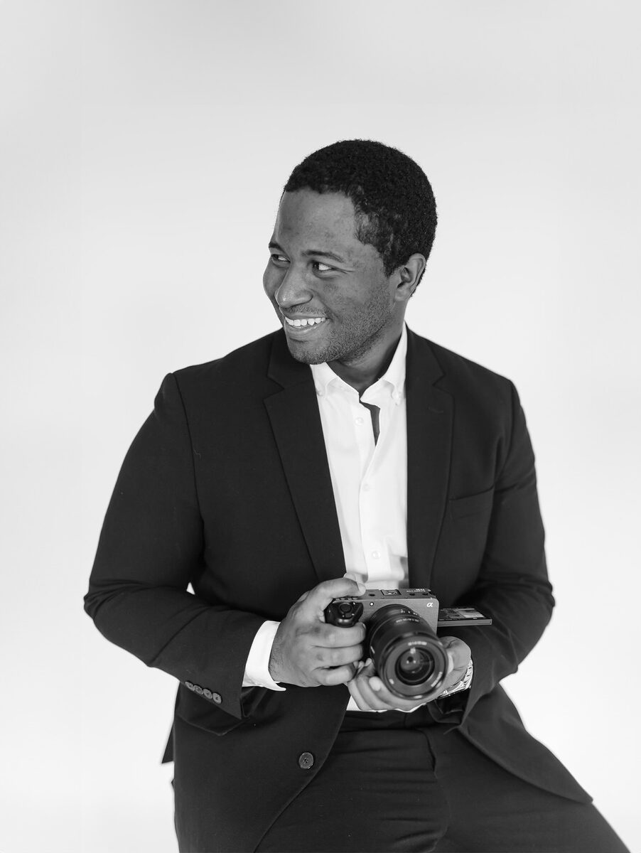 Will, lead videographer at Aurora Adeleigh, holding his camera